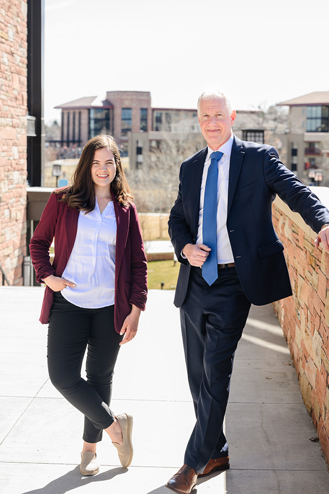 Dr. Parker and Sierra Rose standing outside the Armstrong Center with the CCU campus in the background
