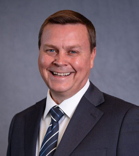 Dr. Peter Kerr smiling in his headshot