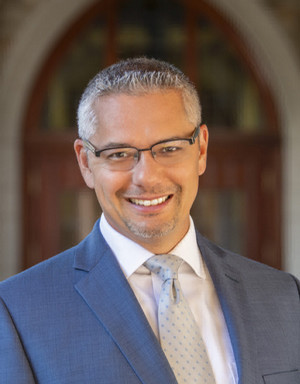Vincent Phillip Muñoz smiling in his headshot